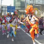 華やかな頭飾りを付けて跳ね踊る。踊り手の先頭には「ミスター跳人（はねと）」が（「青森ねぶた祭」）